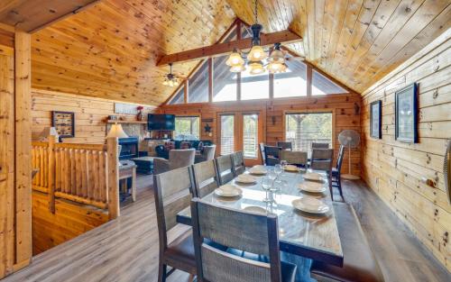 a dining room with a table and chairs in a cabin at Heavenly Escape in Pigeon Forge