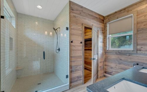 a bathroom with a walk in shower and a shower stall at Hang Yer Hat in Sevierville