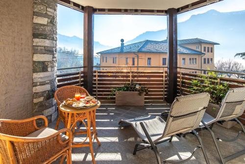 a balcony with chairs and a table with a view at Relais Du Foyer in Châtillon