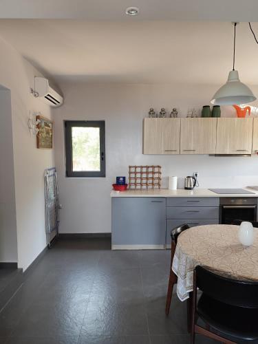 a kitchen with a table and a dining room at Tzouzos-Kordopateika villa in Prosilio, Kardamyli in Prosílion