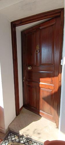 a wooden door in the corner of a room at Hope Nest Pelion in Zagora