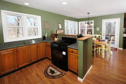 a kitchen with wooden cabinets and a black stove at Mountain Therapy 1123 in Gatlinburg