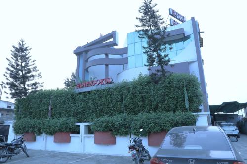 a car parked in front of a building at Hotel Gokul in Gandhidham