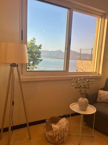 a living room with a window with a view of a bridge at Pelikan Lake House in Shkodër