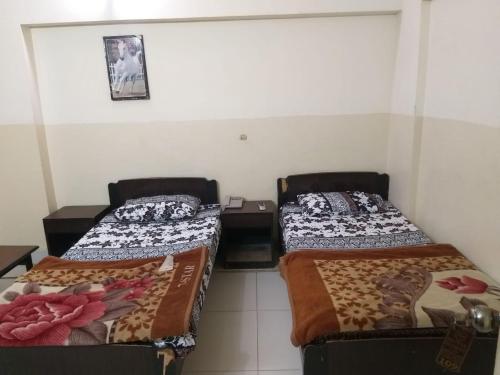 Postel nebo postele na pokoji v ubytování Hotel Zishan