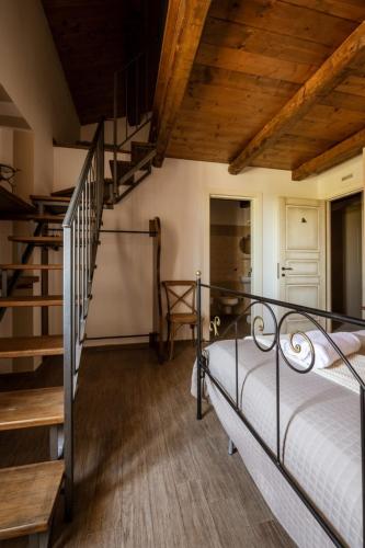 a bedroom with a metal bed and a staircase at Locanda Mammi in Agnone