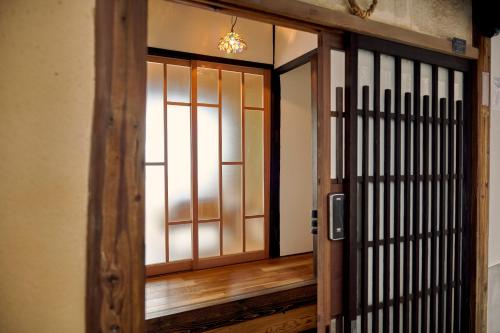 an open door to a room with a wooden floor at 海月 うみづき in Tomo