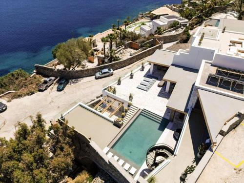 an aerial view of a house with a beach at Villa Lilium I - Overlooking Psarou Bay, Mykonos in Psarou