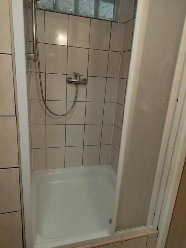 a bathroom with a shower with a bath tub at Mieszkanie Nad Jeziorem in Wilkasy
