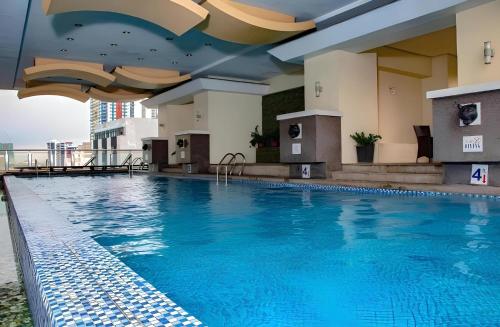 a swimming pool on the roof of a hotel at BirchTower Studio Condo with Balcony & Pool - Carosa Staycation in Manila