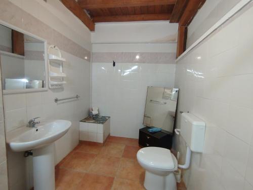 a bathroom with a white toilet and a sink at Casa vacanze La canzone del sole in Torre Squillace