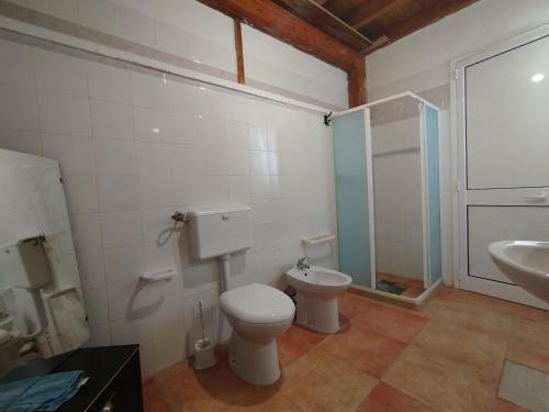 a bathroom with a toilet and a sink at Casa vacanze La canzone del sole in Torre Squillace