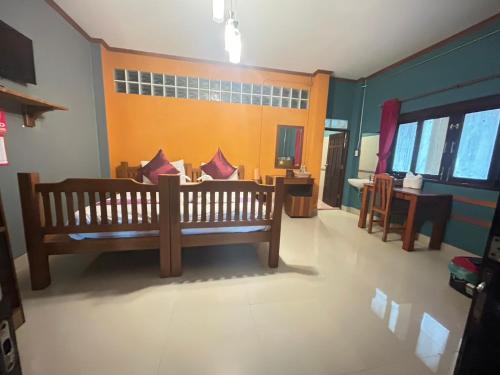 a room with a wooden bench in a room at Araya Boutique Hotel in Thongsala