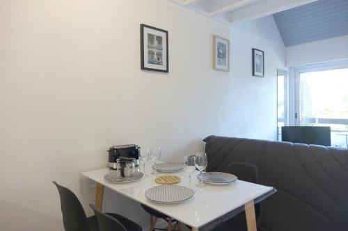 a table with two glasses and a coffee maker on it at Arzon in Arzon