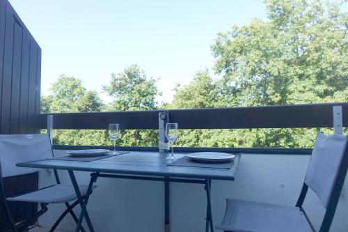 a blue table and chairs on a balcony at Arzon in Arzon