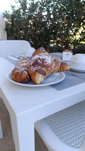 two pastries on a white plate on a table at Butiko in Castelluzzo