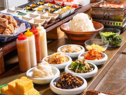 a buffet of different types of food on a table at APA Hotel Nihombashi Bakurocho Ekikita in Tokyo