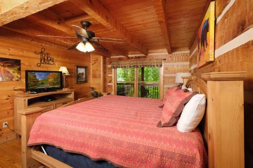 a bedroom with a bed and a ceiling fan at Mountain Splendor 1250 in Gatlinburg