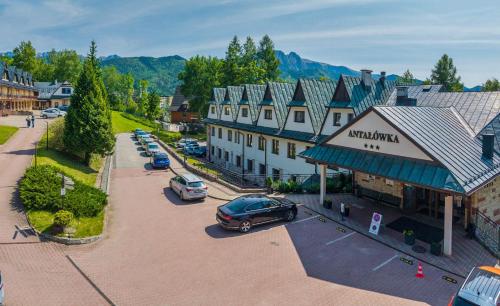 an aerial view of a town with cars parked in a parking lot at Kompleks Antałówka Termy & Med in Zakopane