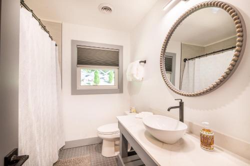 ein weißes Badezimmer mit Waschbecken und Spiegel in der Unterkunft Hidden Hills in Gatlinburg