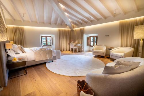 a bedroom with a bed and a living room at Finca Banyols, Vignette Collection by IHG in Alaró