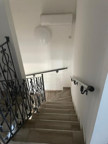 a stairway with a stair railing at Anett Wellis Apartman Poroszló in Pusztavacs