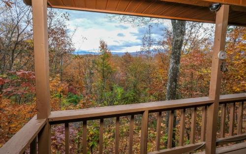 a view from the deck of a cabin in the woods at Serenity in Pigeon Forge