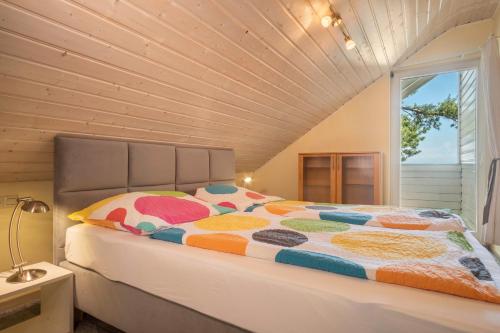 a bedroom with a bed with a large window at Landhaus Bodensee in Deggenhausertal