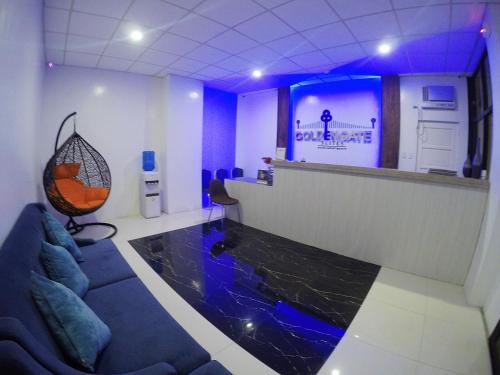 a lobby with a bar with a fish aquarium at Golden Gate Suites in Dumaguete