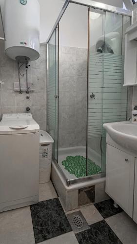 a bathroom with a shower with a glass door at The View Savina - Herceg Novi in Herceg-Novi