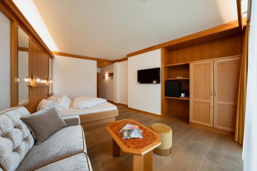 a living room with a couch and a table at Hotel Nocturnes in Naturno