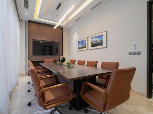 a conference room with a large table and chairs at W Residence Living in Dhaka