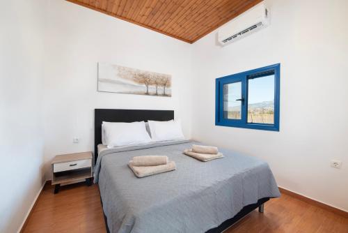 a bedroom with a bed with two towels on it at PARADISE SEA HOUSE a in Haraki