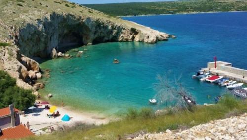 a beach with people and boats in the water at Casa Bellea in Belej