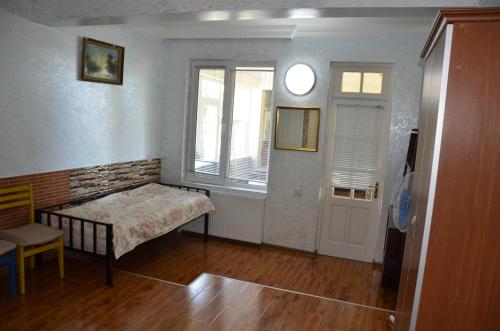 a small room with a bed and a window at TJ Guest House in Makhinjauri