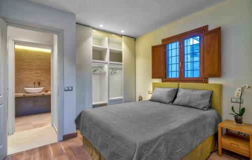 a bedroom with a bed and a bathroom at Belvedere Andros in Batsi