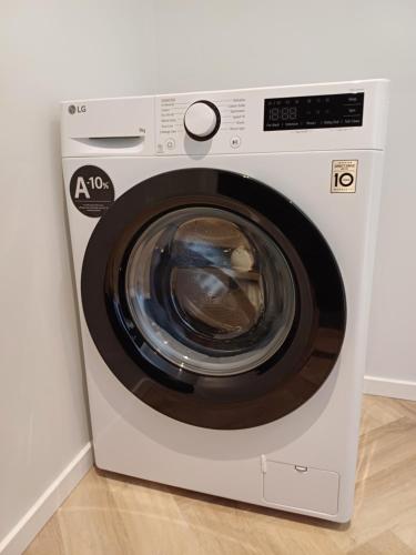 a white washing machine sitting in a room at Luise LuXe Suites in Tallinn