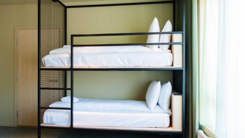 a room with four bunk beds in a room at Citybox Kristiansand in Kristiansand