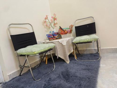 two chairs and a table in a room with a tableablish at Bé Homestay in Hai Phong