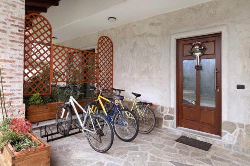 three bikes parked on a porch next to a door at Villa Giulia - Bisalta in Peveragno
