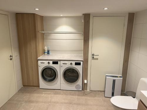 a laundry room with a washer and dryer at Plomben C in Båstad