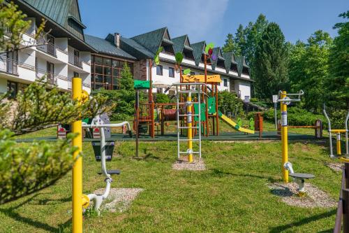 a park with a playground with a slide at Kompleks Antałówka Termy & Med in Zakopane