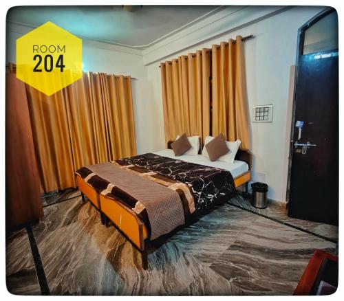 a bedroom with a bed with a yellow sign that says at Shri Ganga View Guest House in Rishīkesh