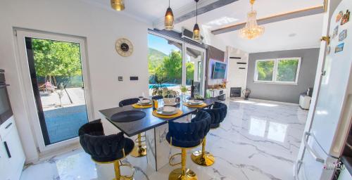 a dining room with a table and chairs at Holiday Home Nova Lux in Mostar