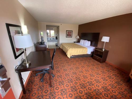 a hotel room with a bed and a desk at Motel 6 Oklahoma City OK Fairgrounds West in Oklahoma City