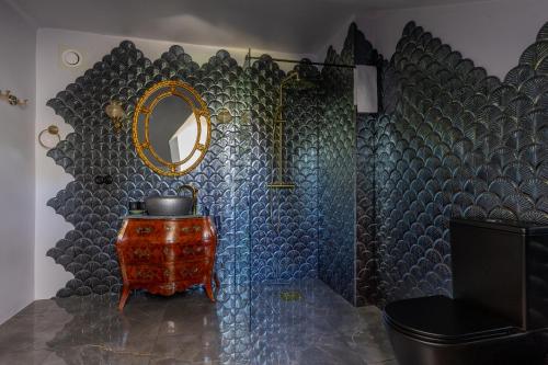 a bathroom with a mirror and a table with a sink at White Brig Guesthouse in Hudiksvall