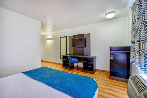 a bedroom with a bed and a desk and a television at Motel 6-Duluth, MN in Duluth