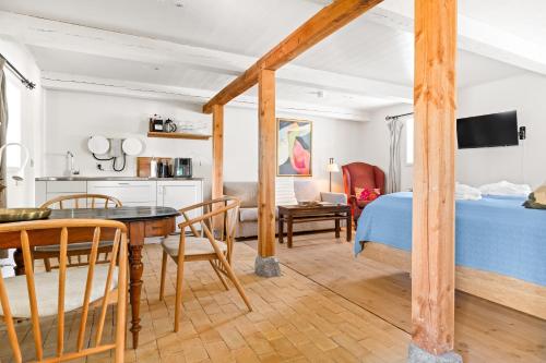 a bedroom with a bed and a dining room at Solbjerggaard Bed & Breakfast in Fåborg