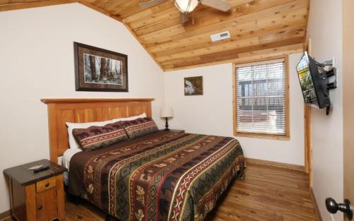 a bedroom with a bed and a tv in a room at Coppertop View in Gatlinburg
