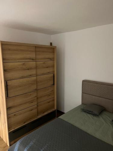 a bedroom with a bed and a wooden dresser at Kasia in Budva